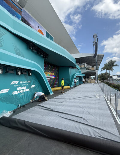 Commercial event carpet installation at the F1 Miami Grand Prix podium stage